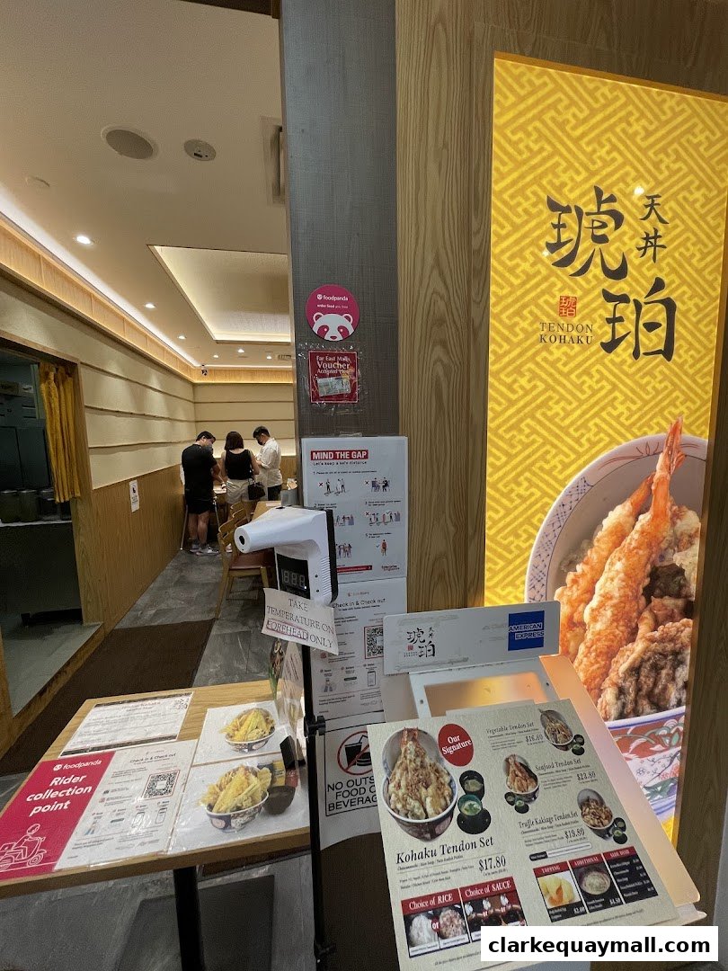 Entrance of Tendon Kohaku restaurant with a menu and temperature scanner visible.