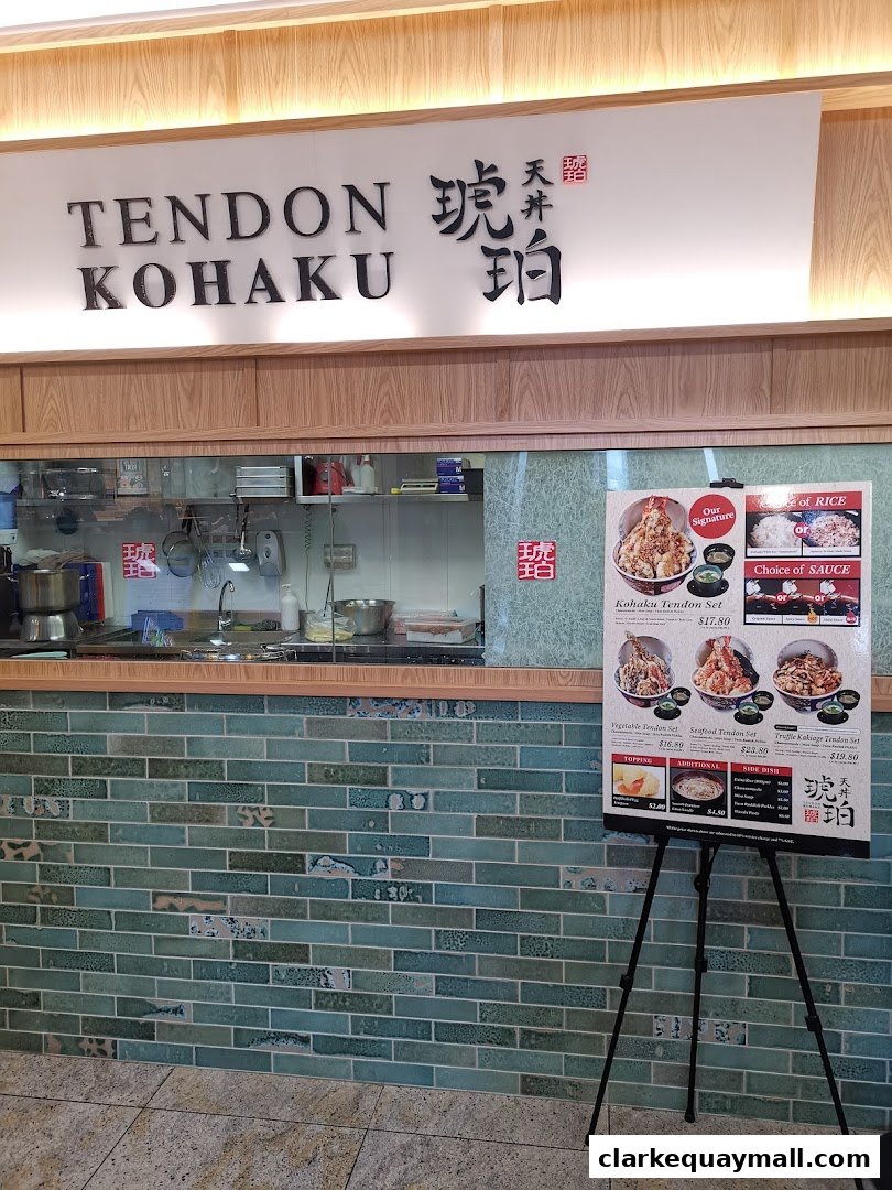 The entrance of Tendon Kohaku, a Japanese restaurant, with its sign and a menu displayed.
