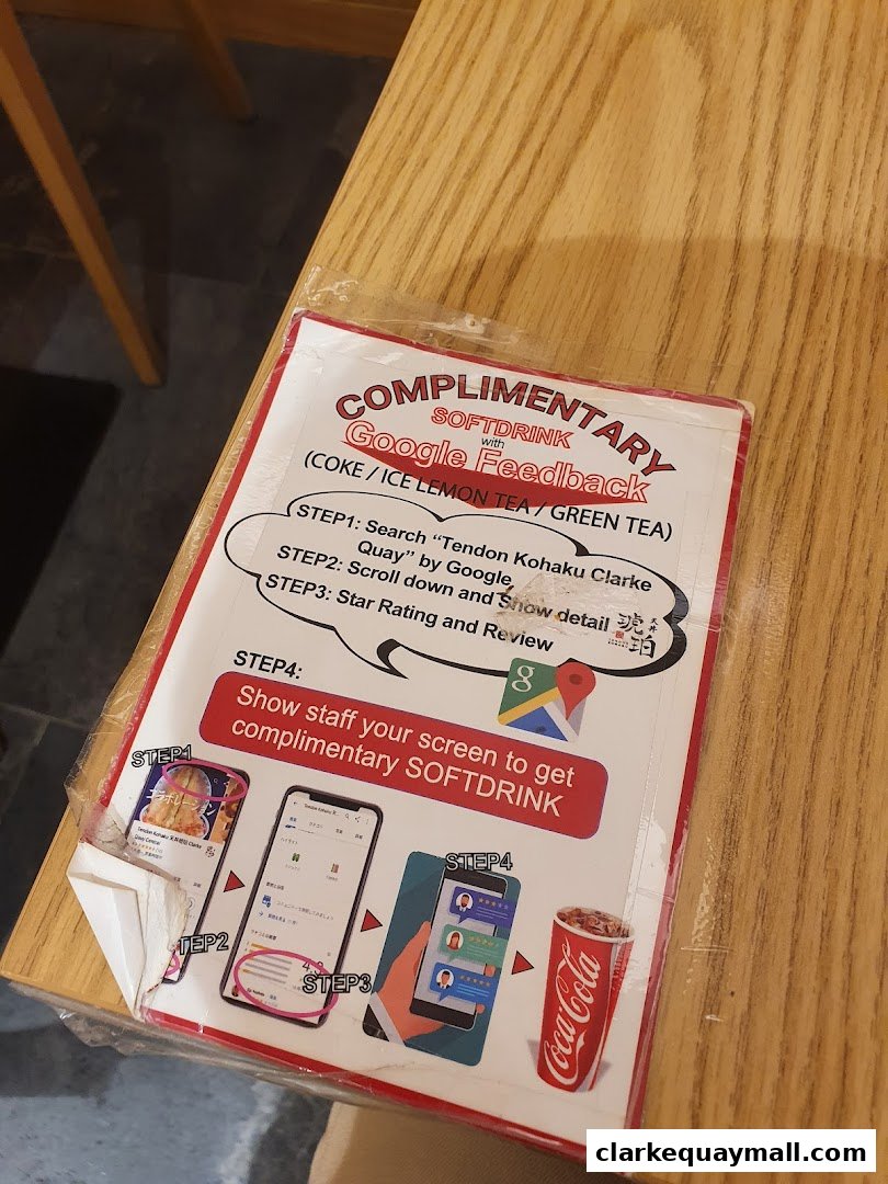 A flyer offering a complimentary soft drink for Google feedback at Tendon Kohaku.