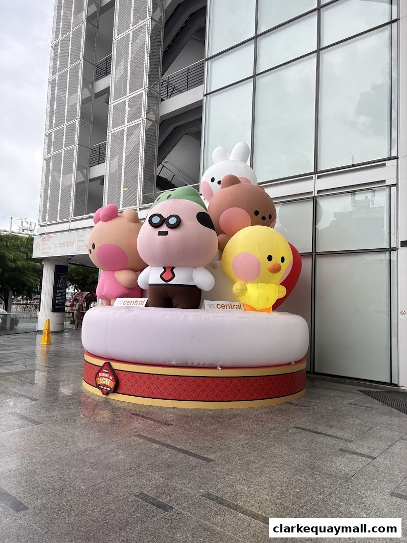 Inflatable cartoon characters displayed outside a modern building with glass windows.