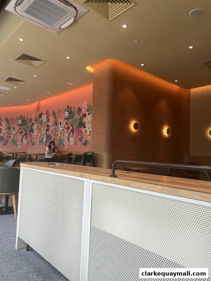 Interior of a cafe with a vibrant mural and modern seating.