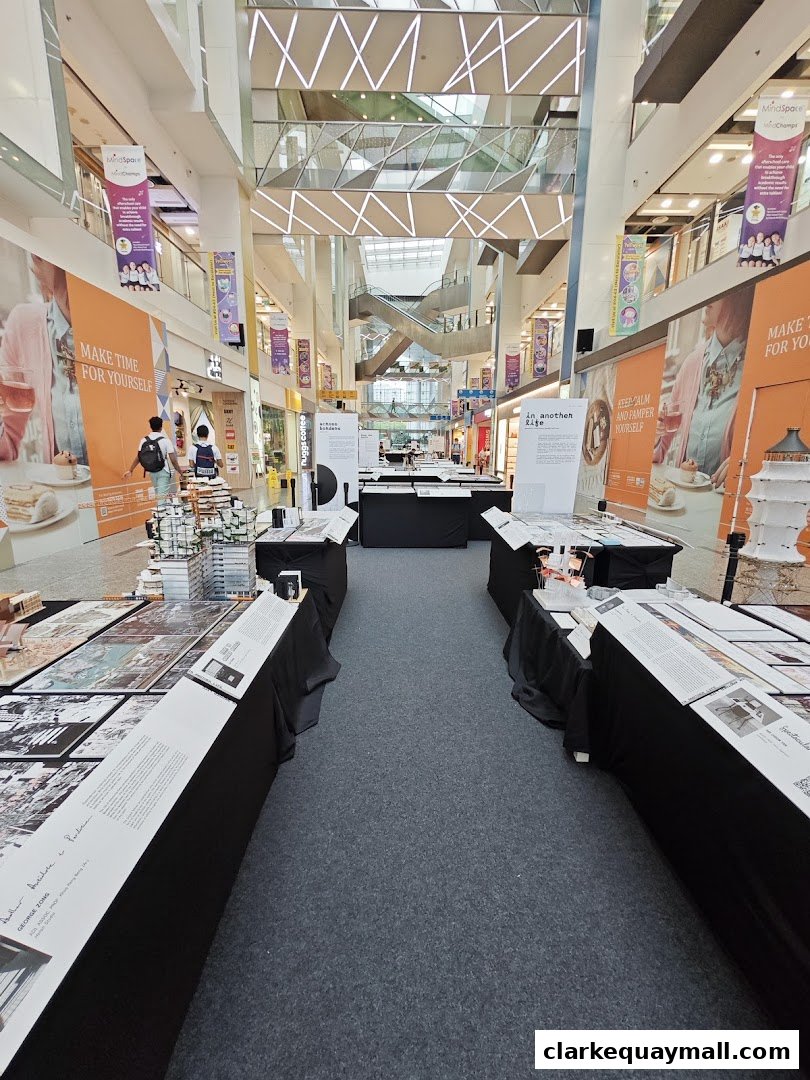 An indoor exhibition with displays of architectural models and prints.