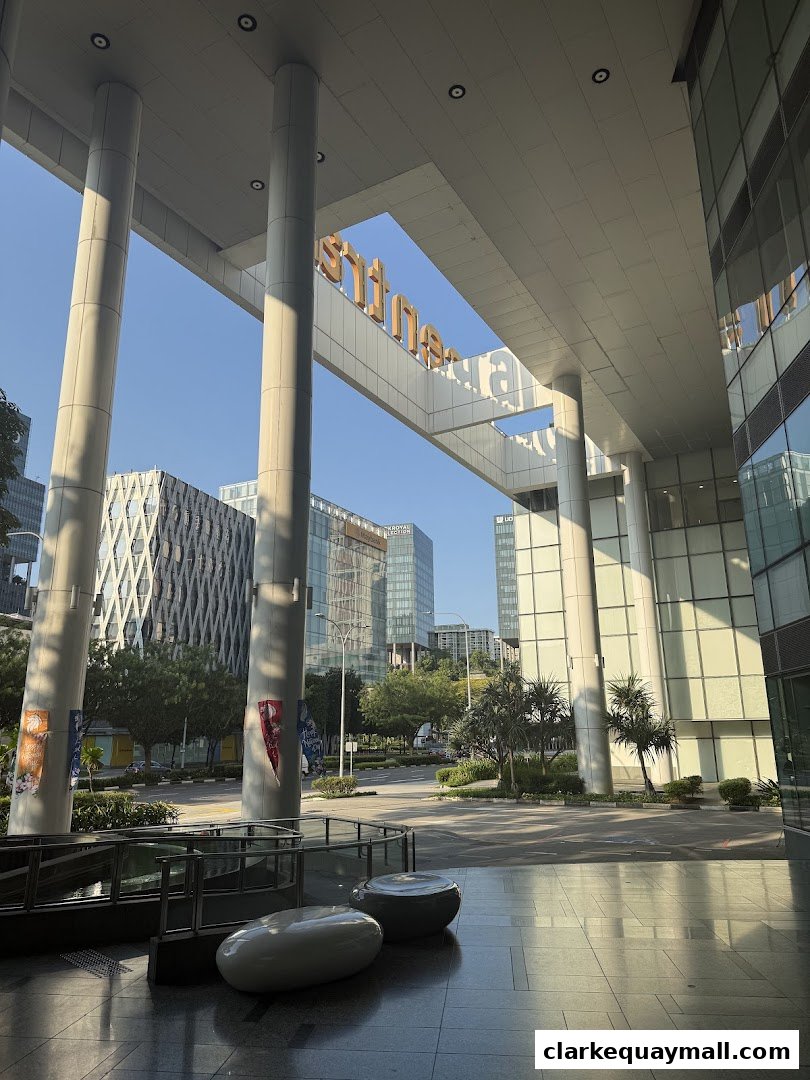 Modern architecture with large pillars and a sign for 'The Central' shopping mall.