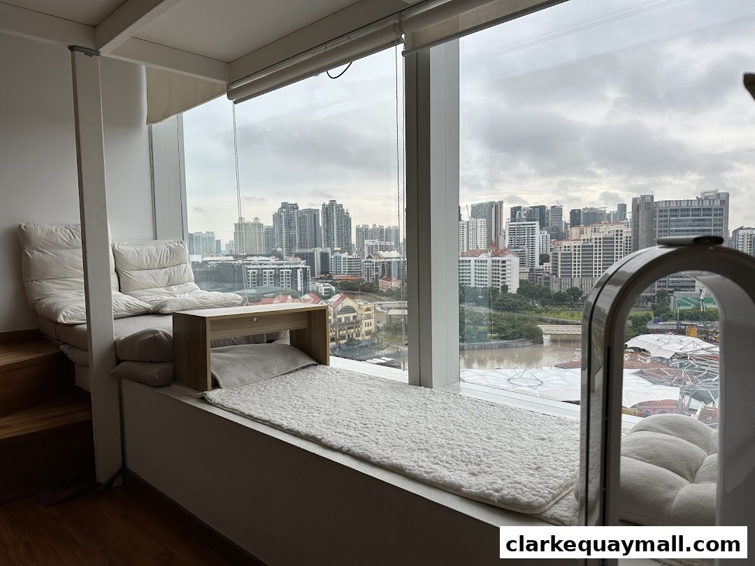 Cozy seating area with a city view, featuring plush cushions and a small wooden table.