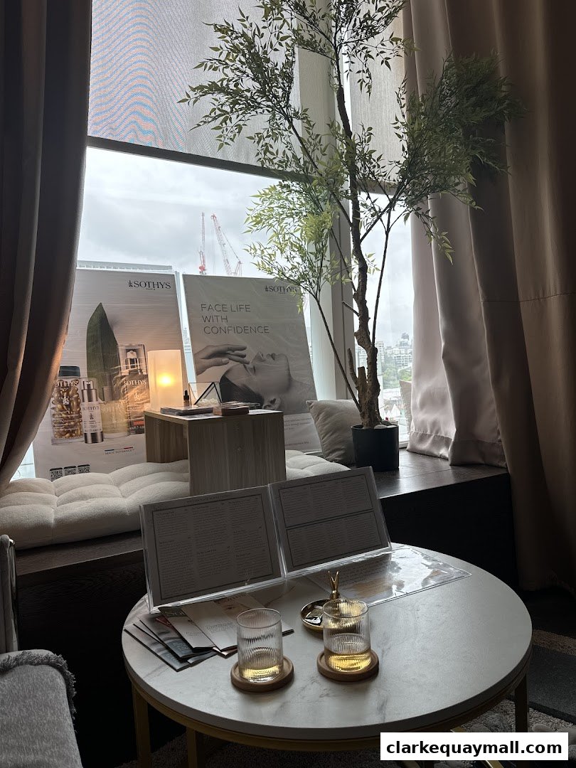 A cozy waiting area with a table, drinks, and Sothys beauty product displays.