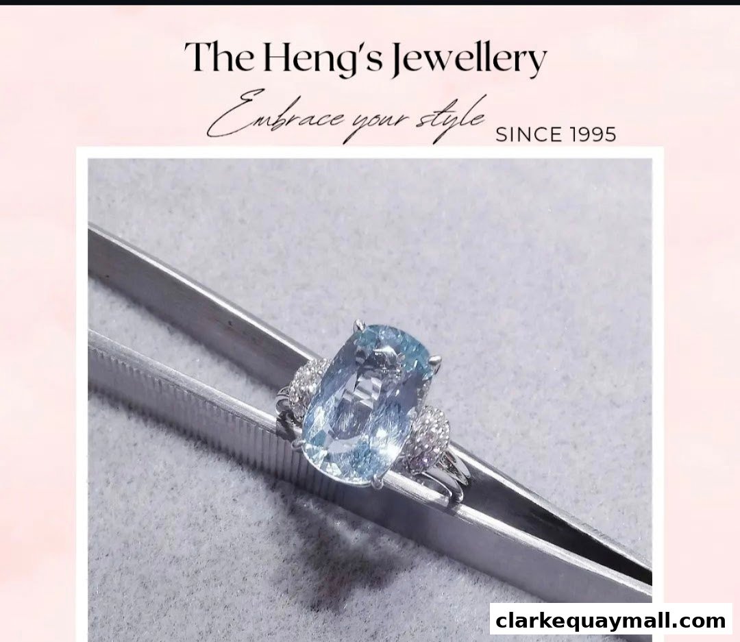 A stunning aquamarine ring with diamond accents held by tweezers.