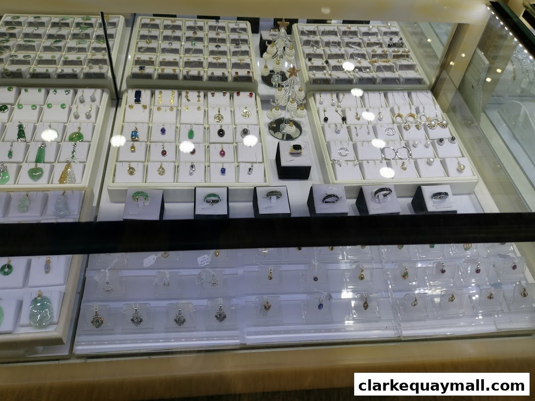 A display case filled with various jewelry items, including pendants, earrings, and rings.