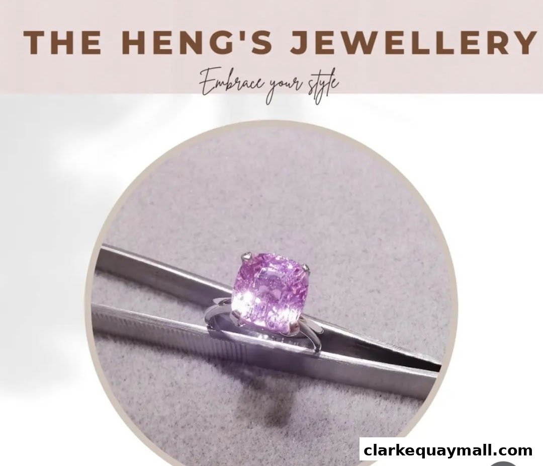 A close-up of a pink gemstone ring held by tweezers, with the shop name and slogan above.