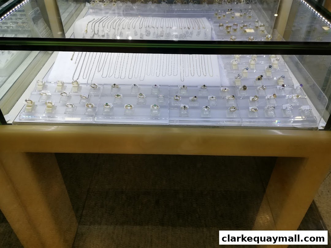 A display case filled with various necklaces and rings at The Hengs Jewellery.