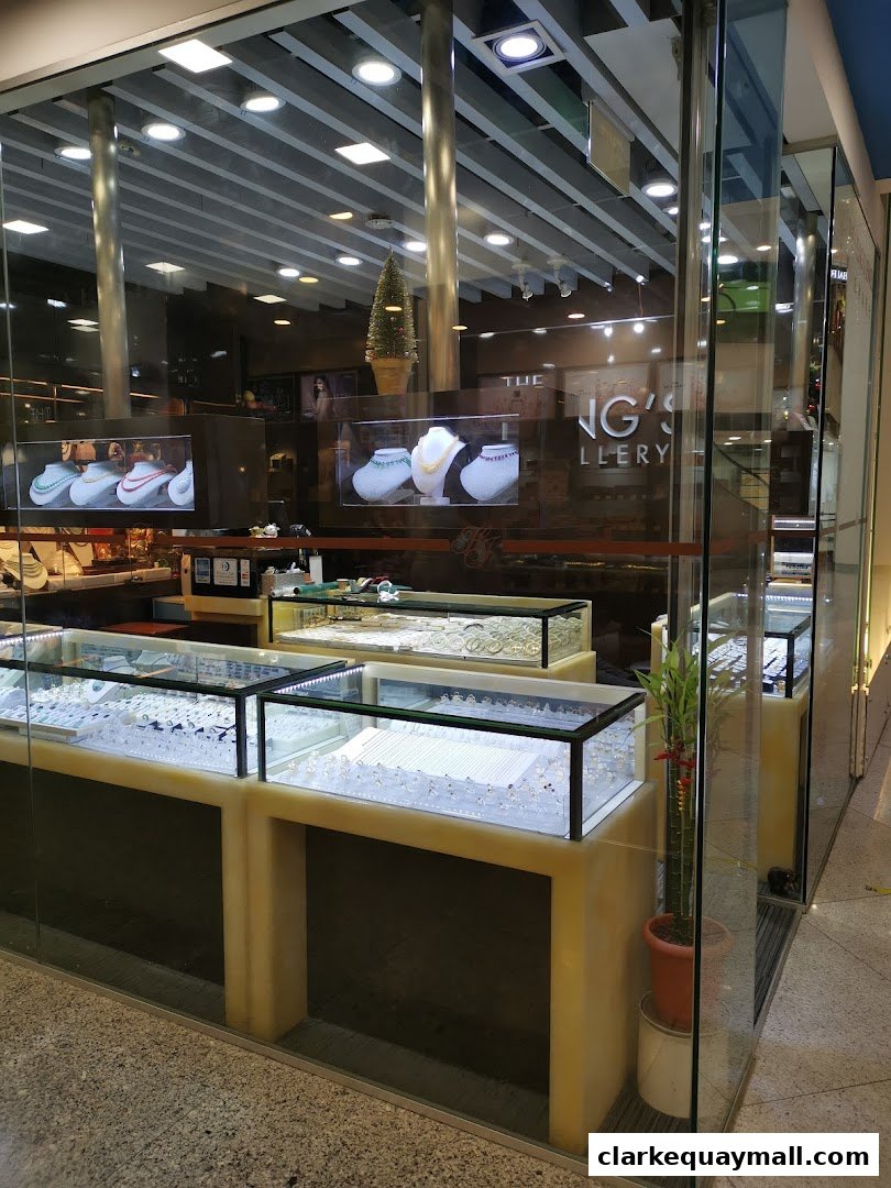 The Hengs Jewellery shop front displays illuminated jewelry cases filled with rings and necklaces.