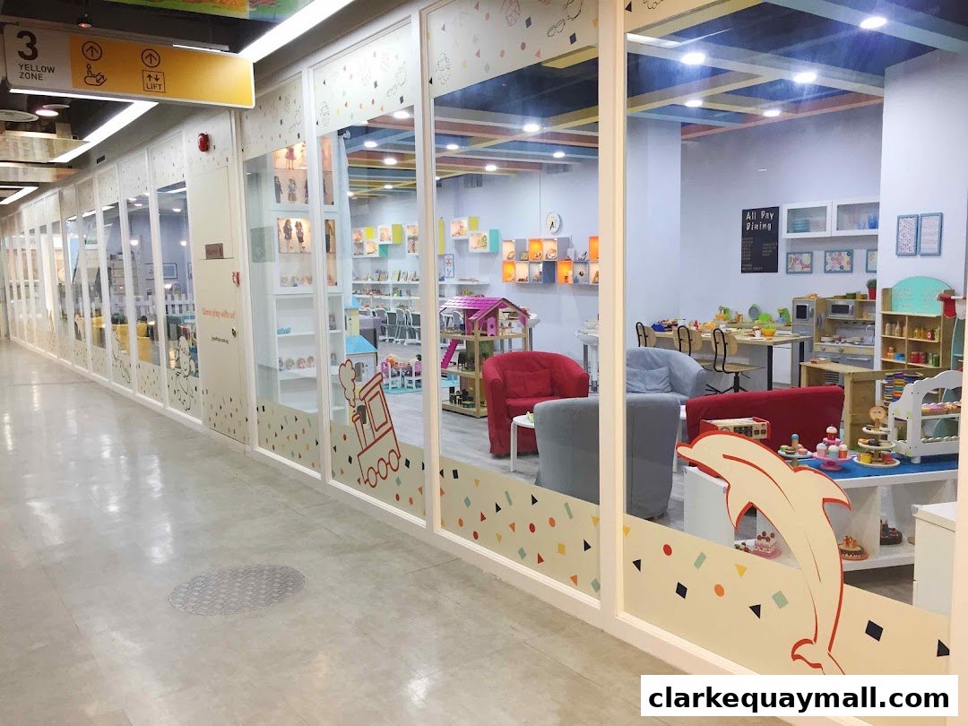Interior view of a brightly lit toy store with play areas and shelves of toys.