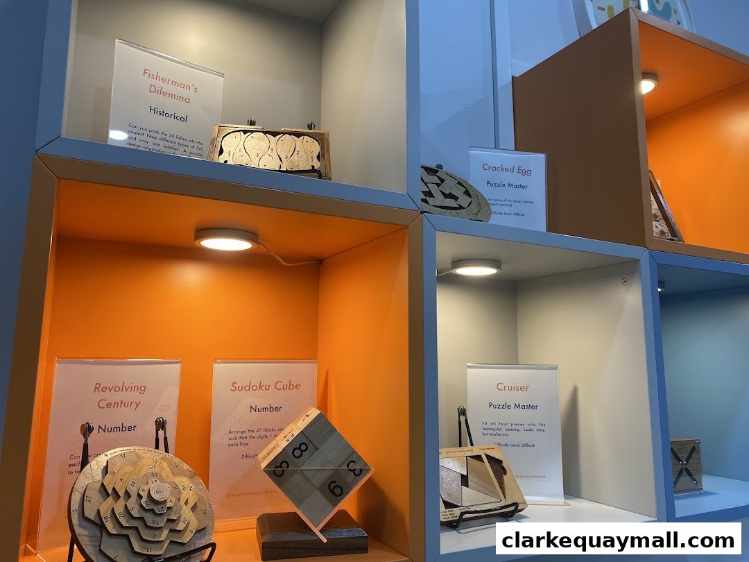 Display shelves showcasing various wooden puzzles with descriptive labels and accompanying puzzle pieces.