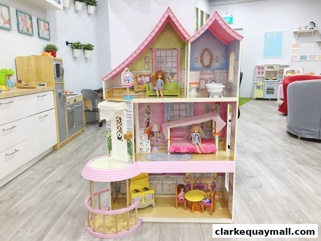 A large, multi-story dollhouse with furniture and dolls, set in a bright, clean play area.