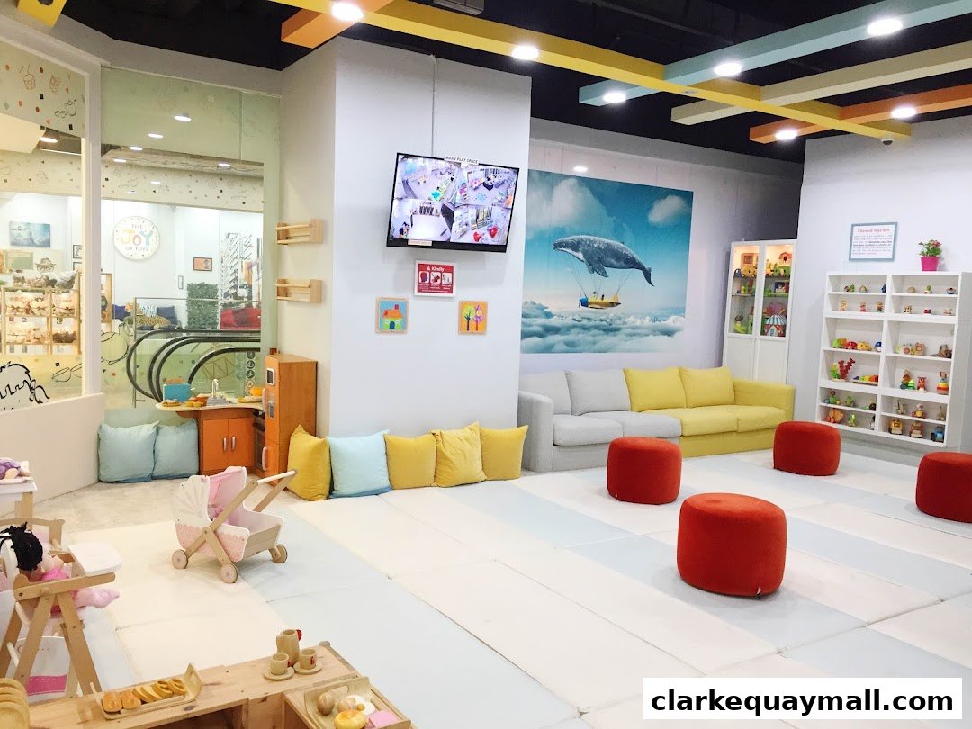 Interior of a bright and colorful toy store with play areas and seating.