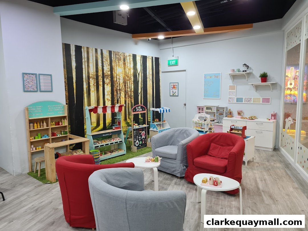 Interior of a toy shop with play areas, seating, and toy displays.
