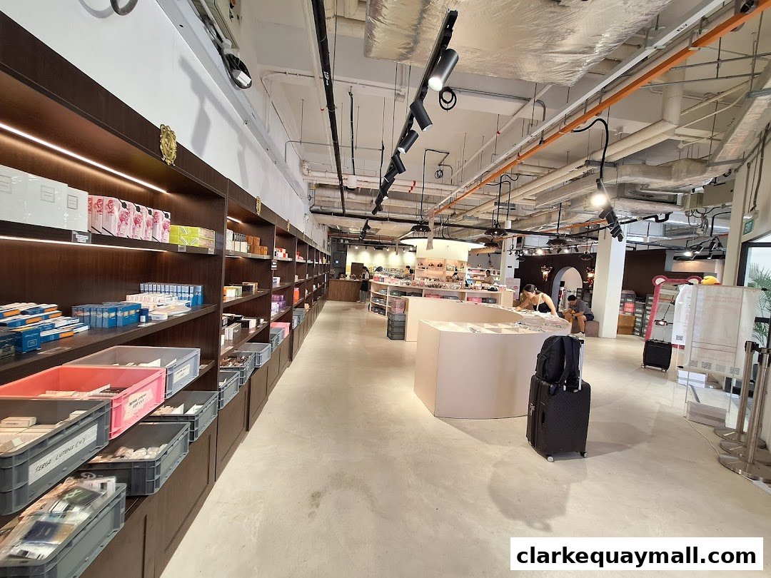 Interior view of a retail store with shelves stocked with various products and display counters.