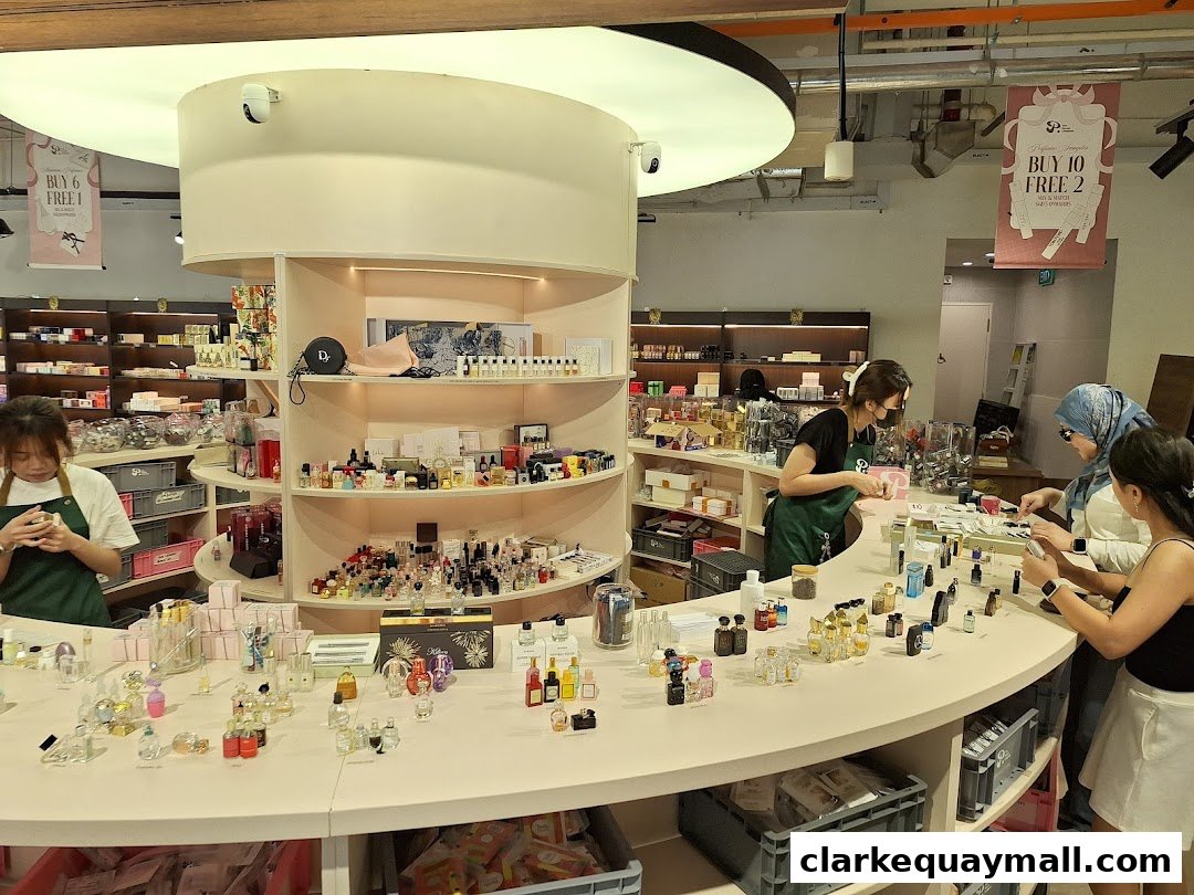 Customers browse a wide selection of perfumes and fragrances at a well-lit retail store.