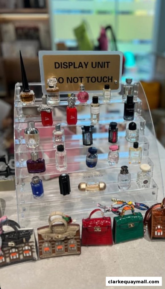 A display of miniature perfume bottles and small handbag accessories.