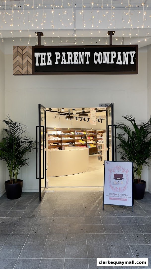 The entrance to The Parent Company shop, featuring a sign, plants, and an open doorway.