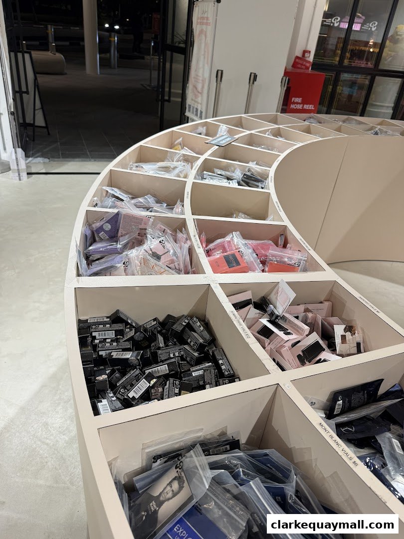 A curved display shelf filled with small boxed items and packaged goods at The Parent Company Singapore.