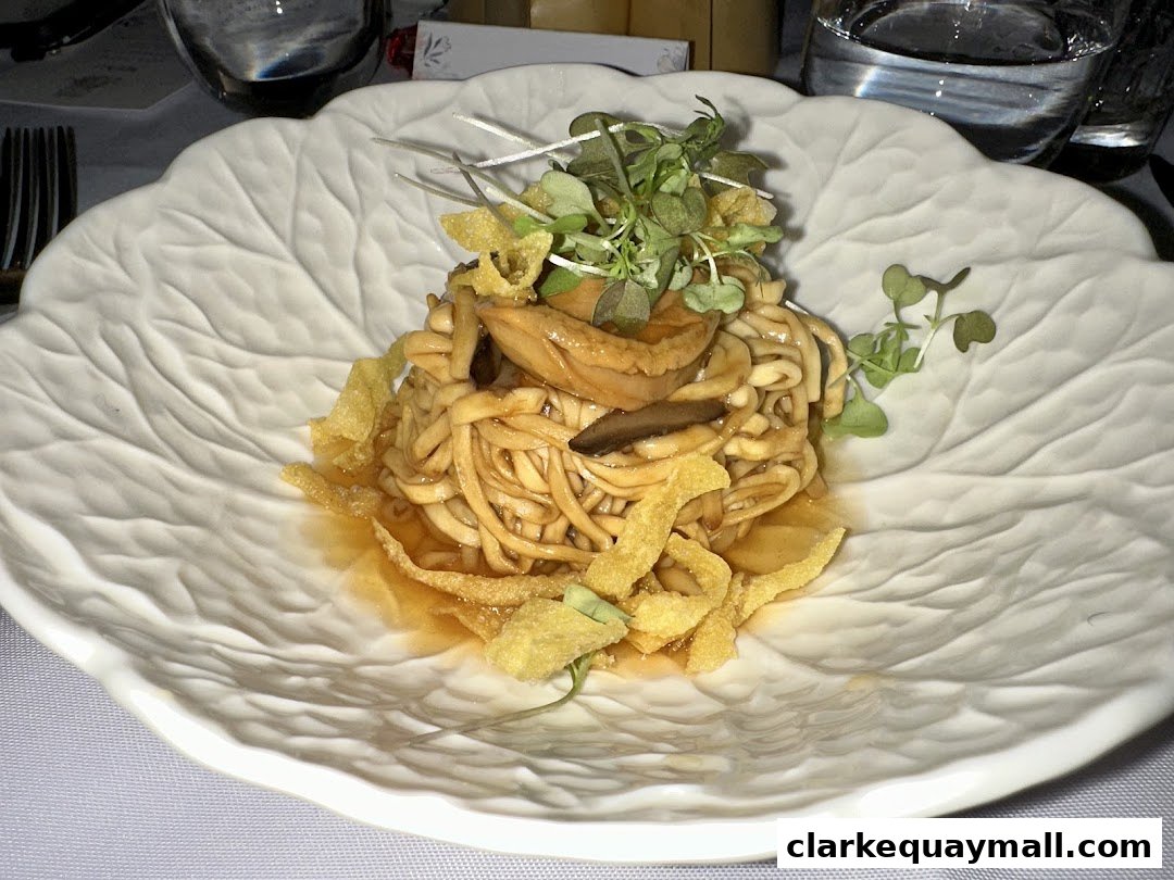 A close-up of a delicious noodle dish served on a leaf-shaped plate.