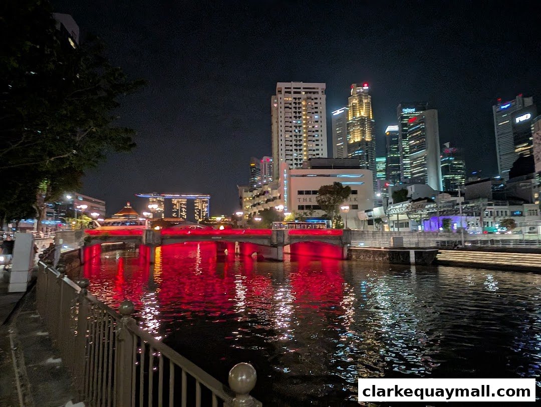 A nighttime view of a river with illuminated bridges and city skyline.
