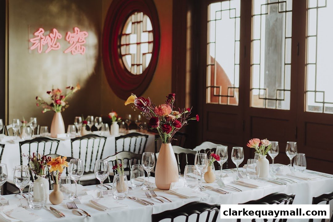 A beautifully set dining table with floral arrangements and neon signage.