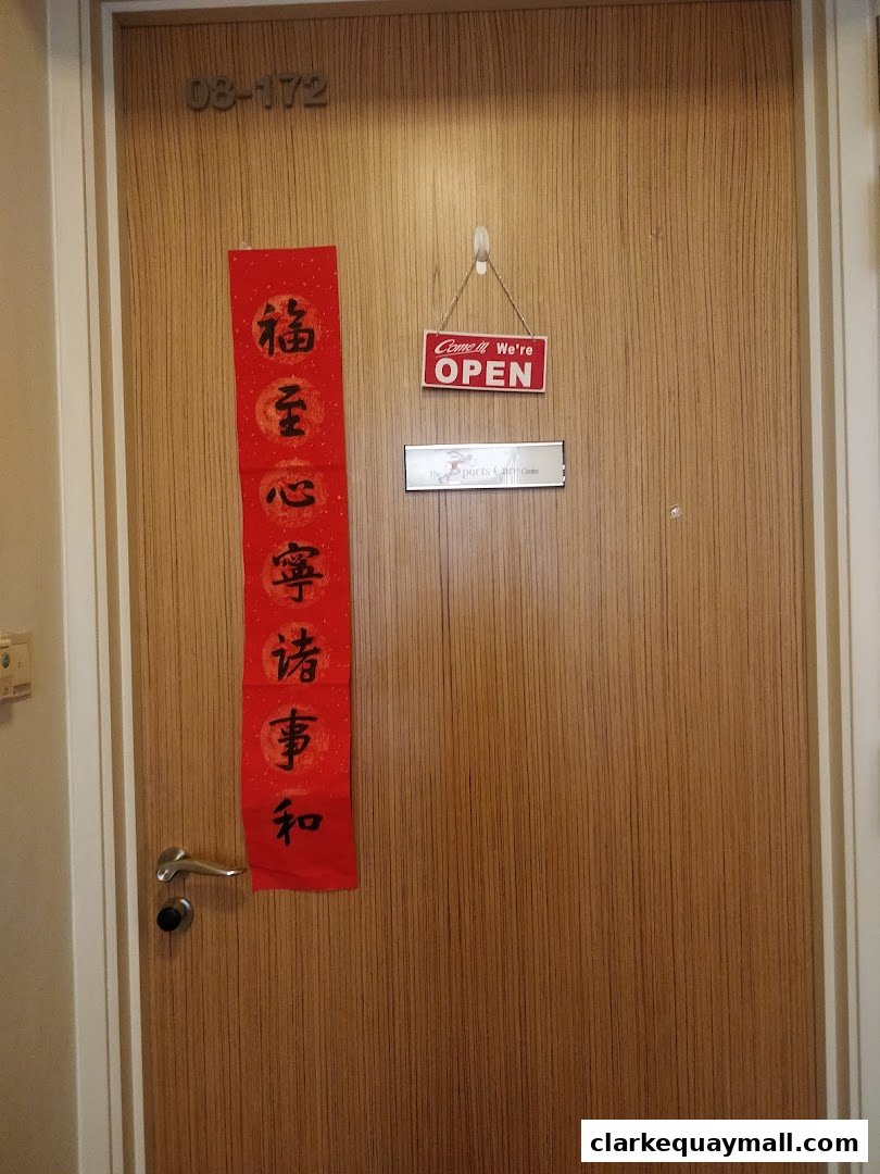 A wooden door with an 'Open' sign and Chinese calligraphy.