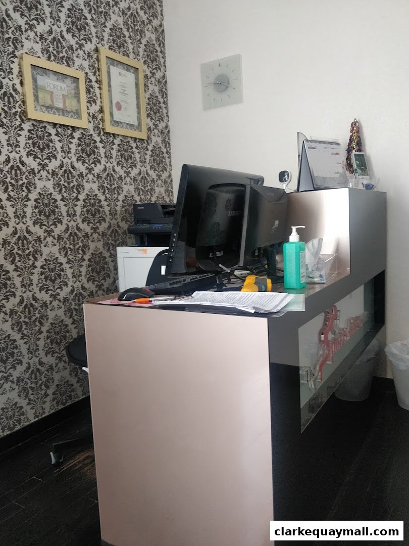A reception desk with computers, paperwork, and decorative items.