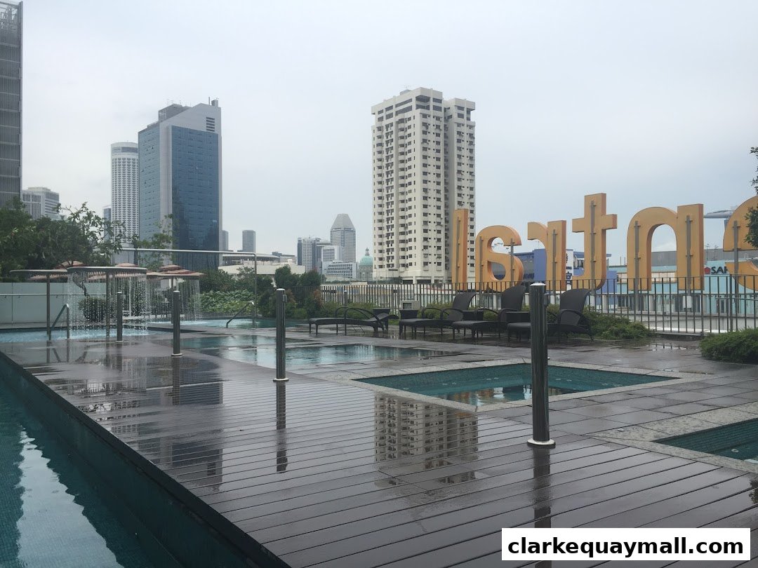 A rooftop pool area with lounge chairs and a large sign that says 'Santara'.