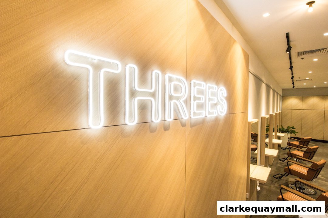 Interior of a modern salon with neon sign and styling chairs.
