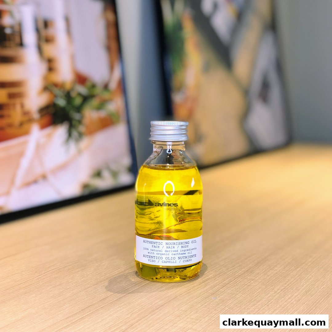A bottle of Davines Authentic Nourishing Oil for face, hair, and body.