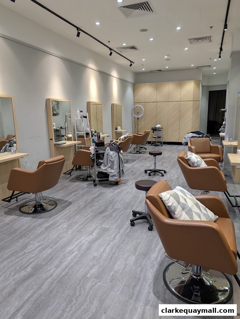 Interior of a modern beauty salon with styling chairs, mirrors, and wooden cabinetry.