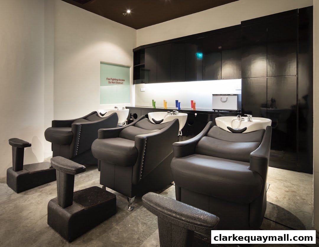 Interior of a modern beauty salon with comfortable reclining chairs and sinks.