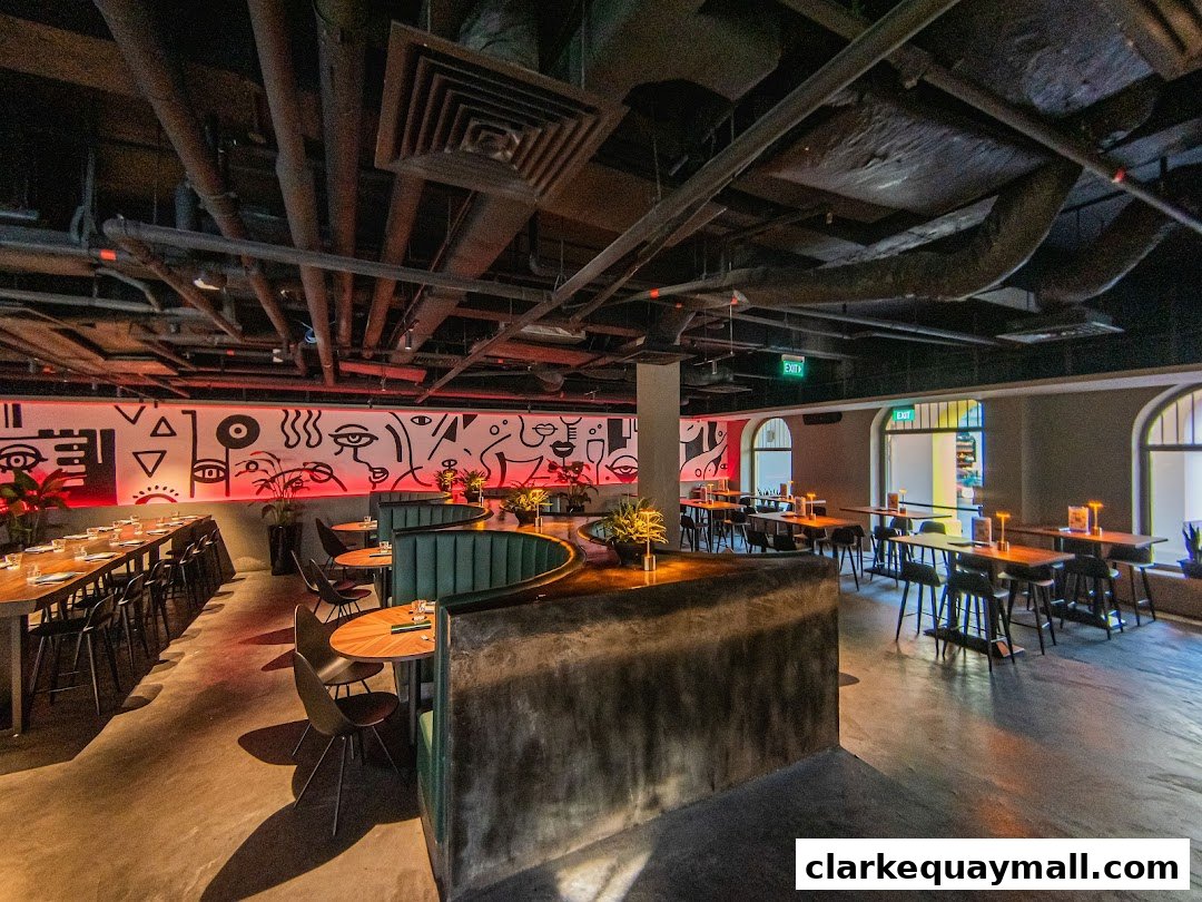Interior of a modern restaurant with artistic wall murals and diverse seating arrangements.