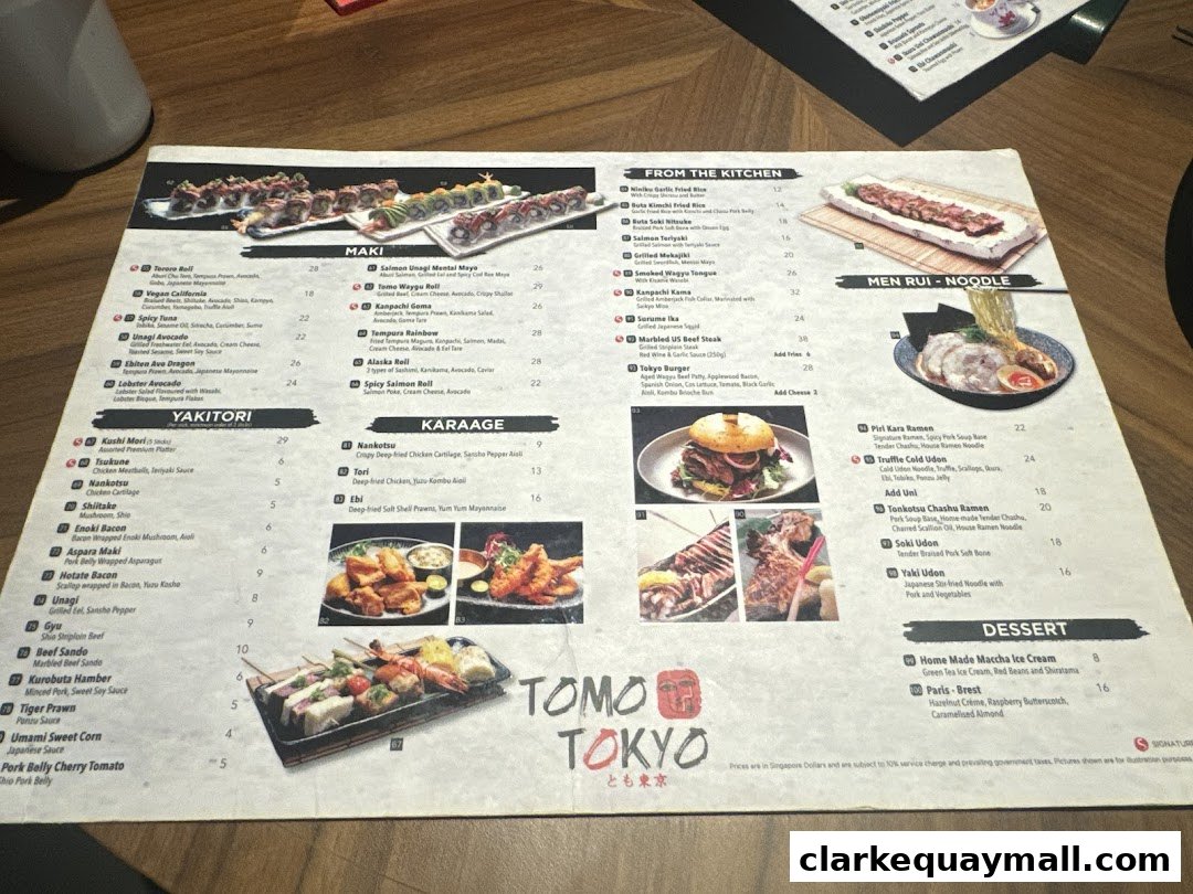 A menu from Tomo Tokyo featuring Maki, Yakitori, Karaage, From the Kitchen, Men Rui, and Dessert items.