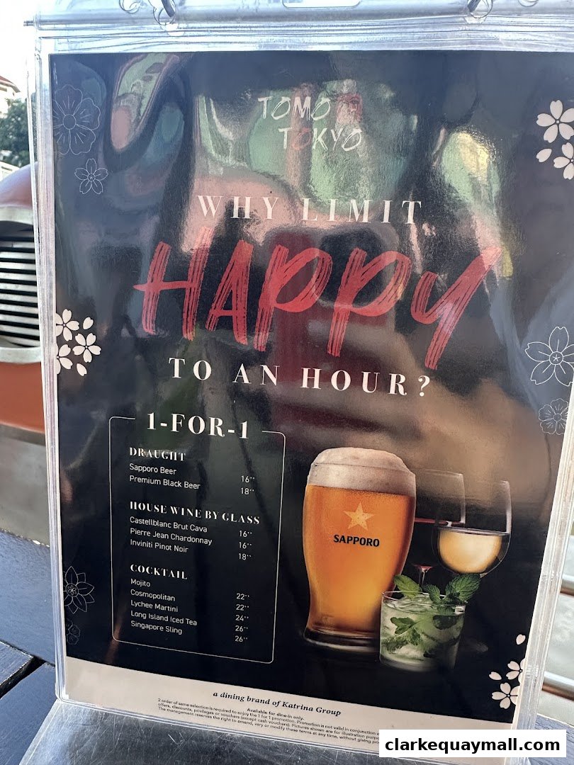 A menu from Tomo Tokyo featuring a 1-for-1 happy hour promotion with drinks.