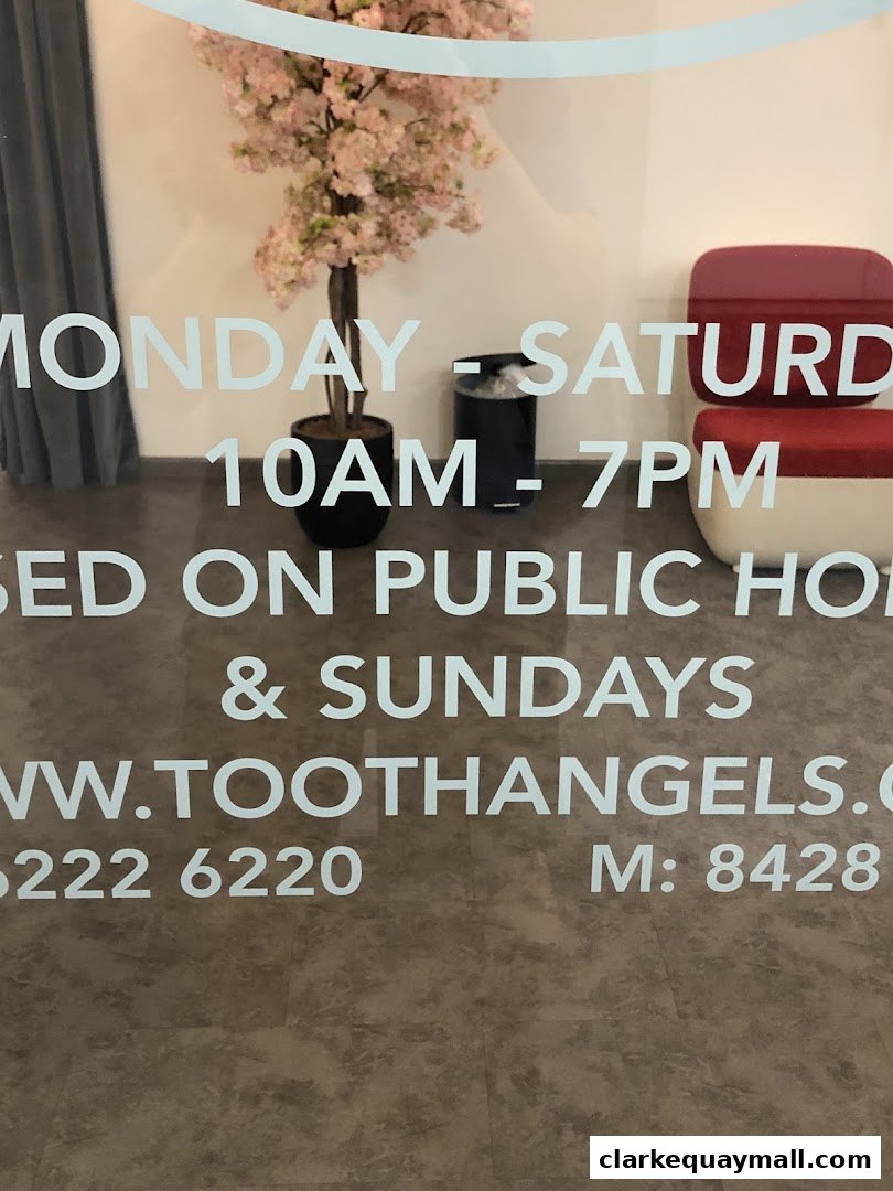 The entrance of TOOTH ANGELS Dental Surgeons, showing operating hours and contact information.
