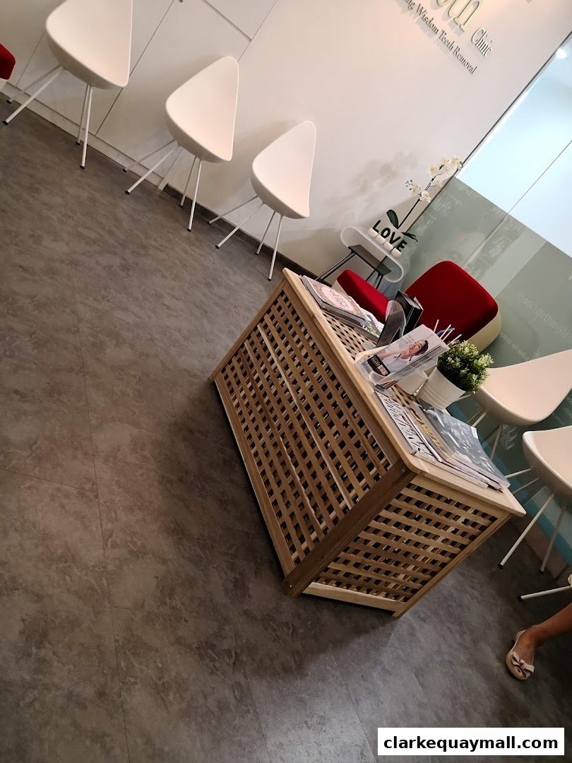 A waiting area with modern chairs, a wooden coffee table, and decorative elements.