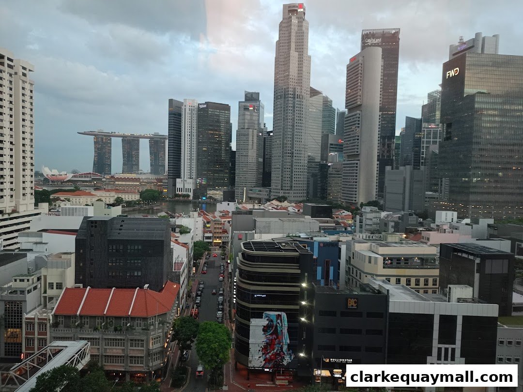 A panoramic view of a city skyline with modern skyscrapers and older buildings.