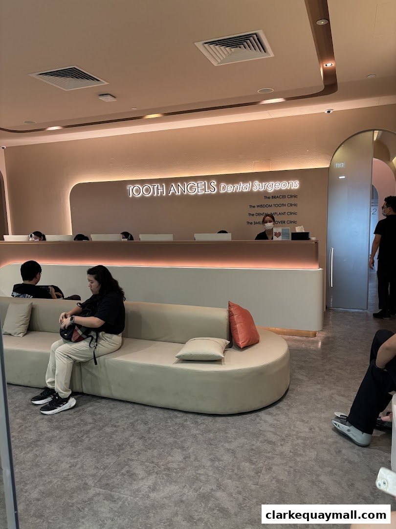 Interior of a modern dental clinic with a reception desk and waiting area.