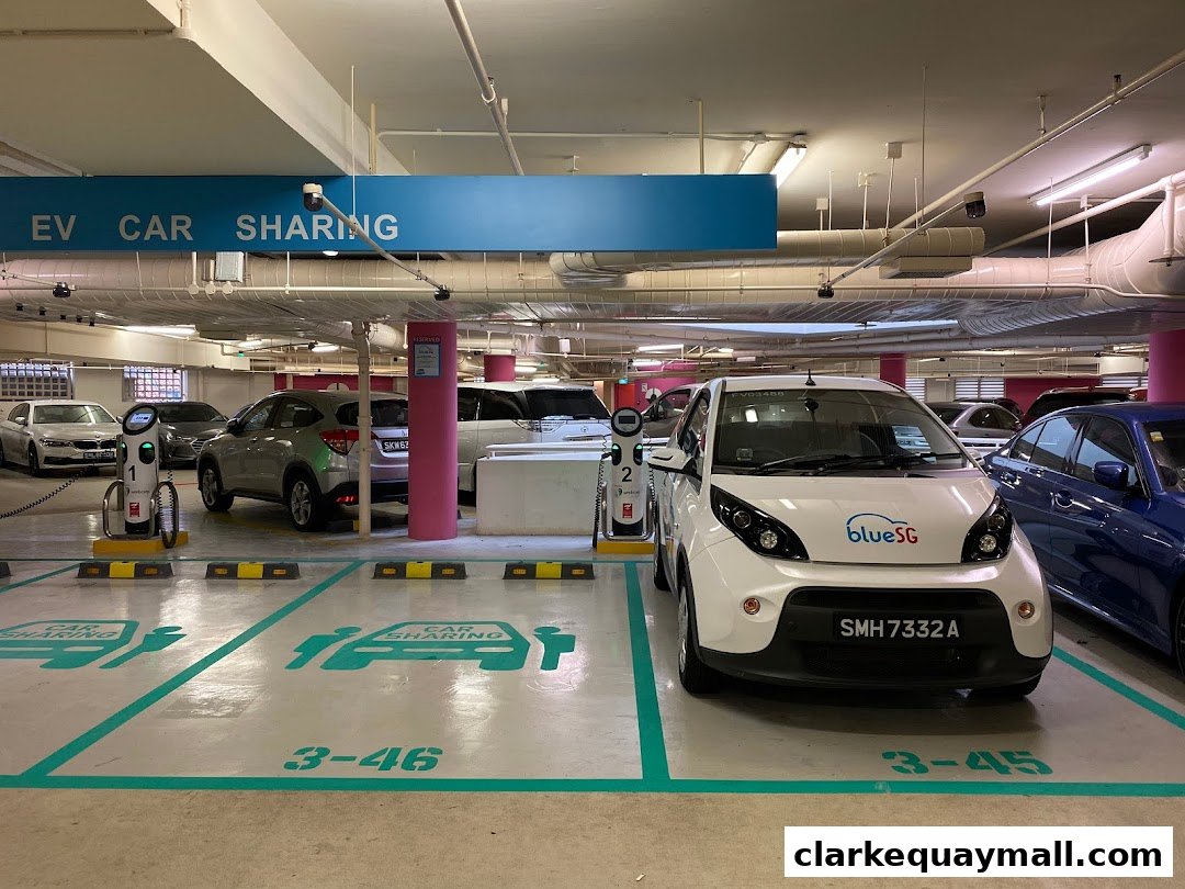 Electric vehicle charging stations and car sharing spots in a parking garage.