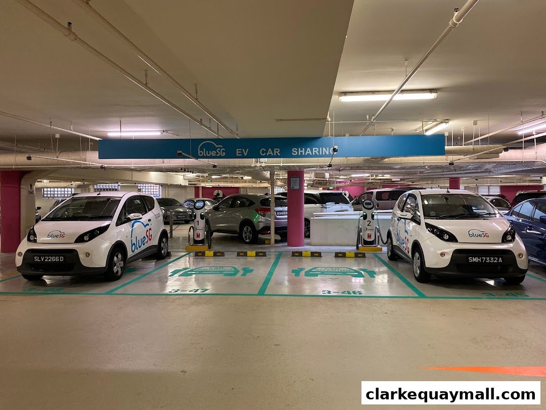 Electric cars parked at charging stations in a parking garage.