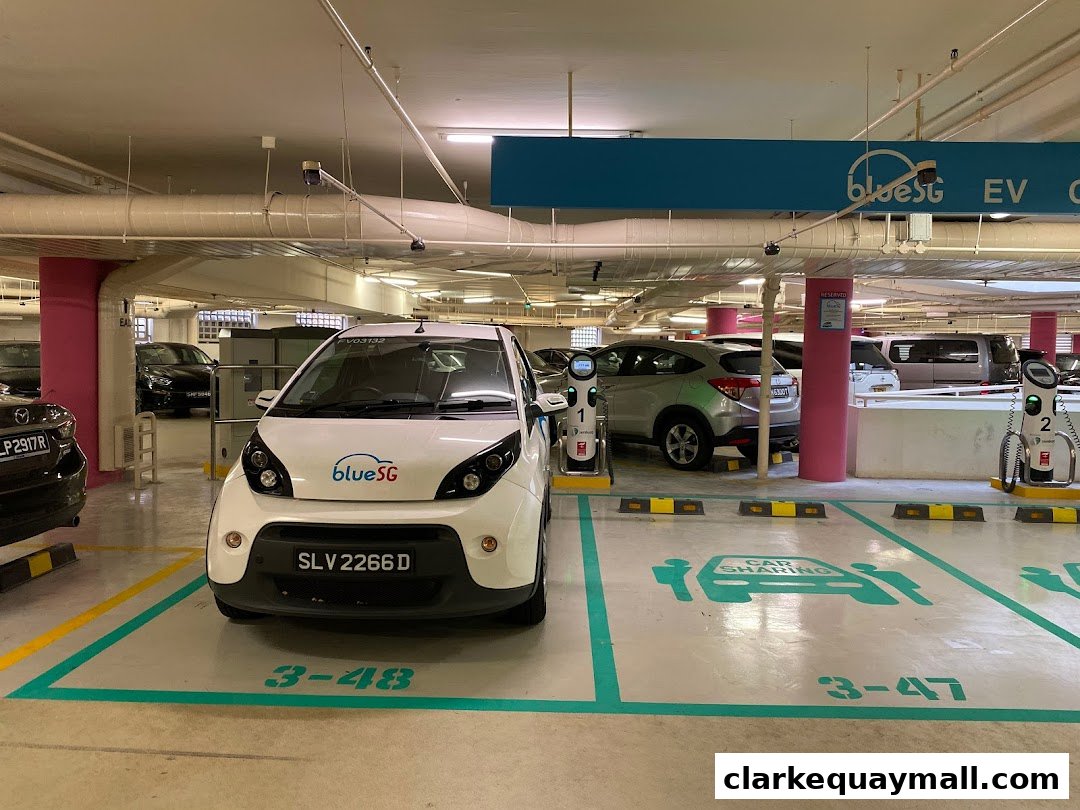 Electric vehicle charging stations and car sharing spots in a parking garage.