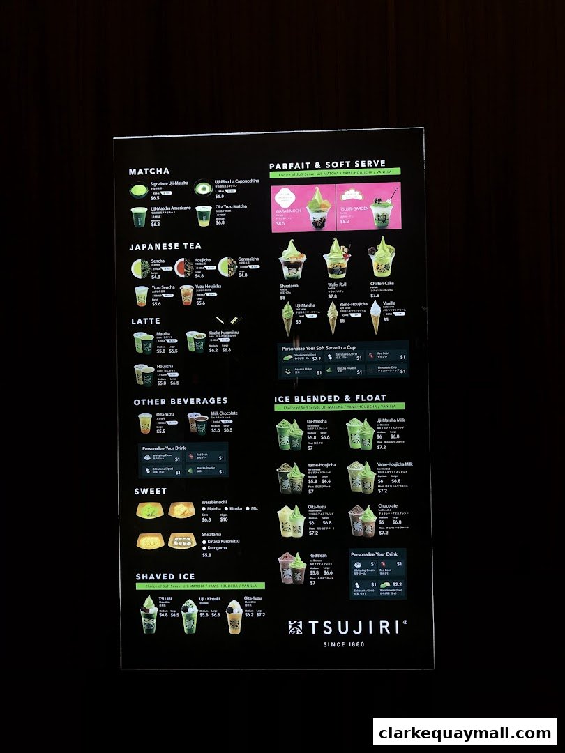 A brightly lit menu board for TSUJIRI, showcasing various matcha and Japanese tea desserts and drinks.