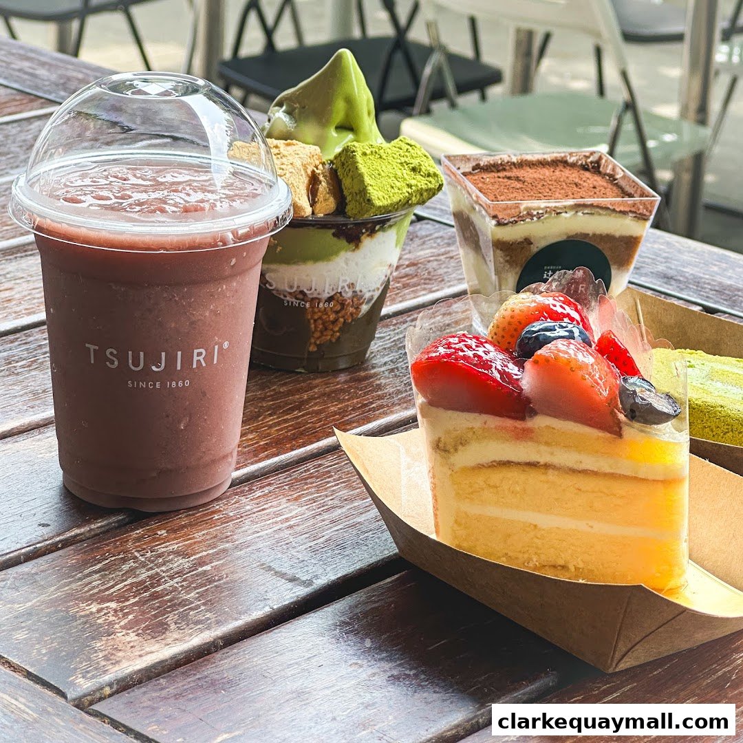 A variety of delicious desserts and drinks from TSUJIRI The Central Store are displayed on a wooden table.