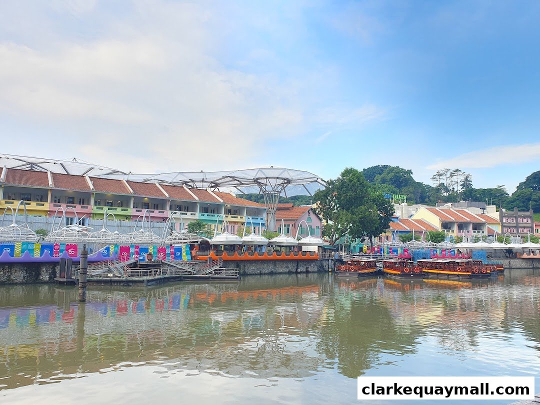 A scenic view of a waterfront with colorful buildings and boats docked along the river.