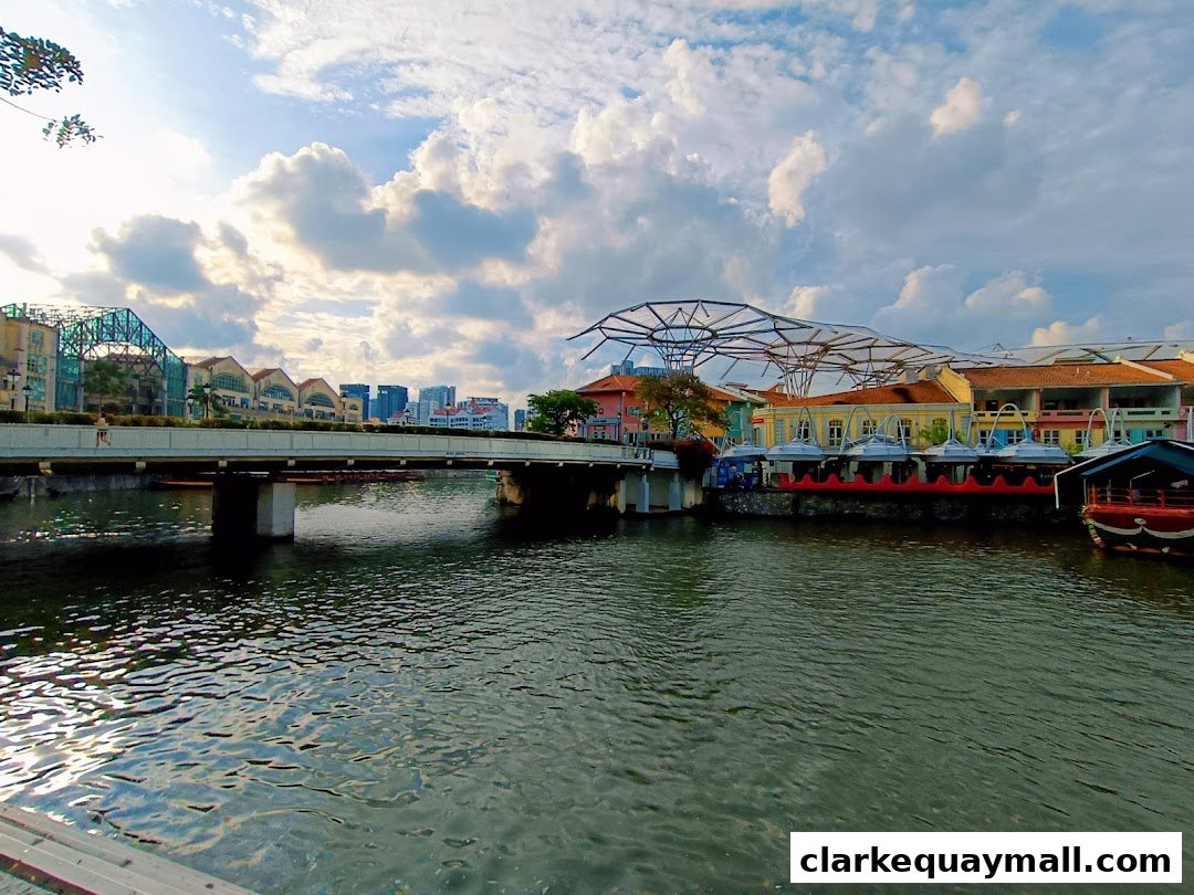 A scenic view of a river with a bridge and colorful buildings along the waterfront.