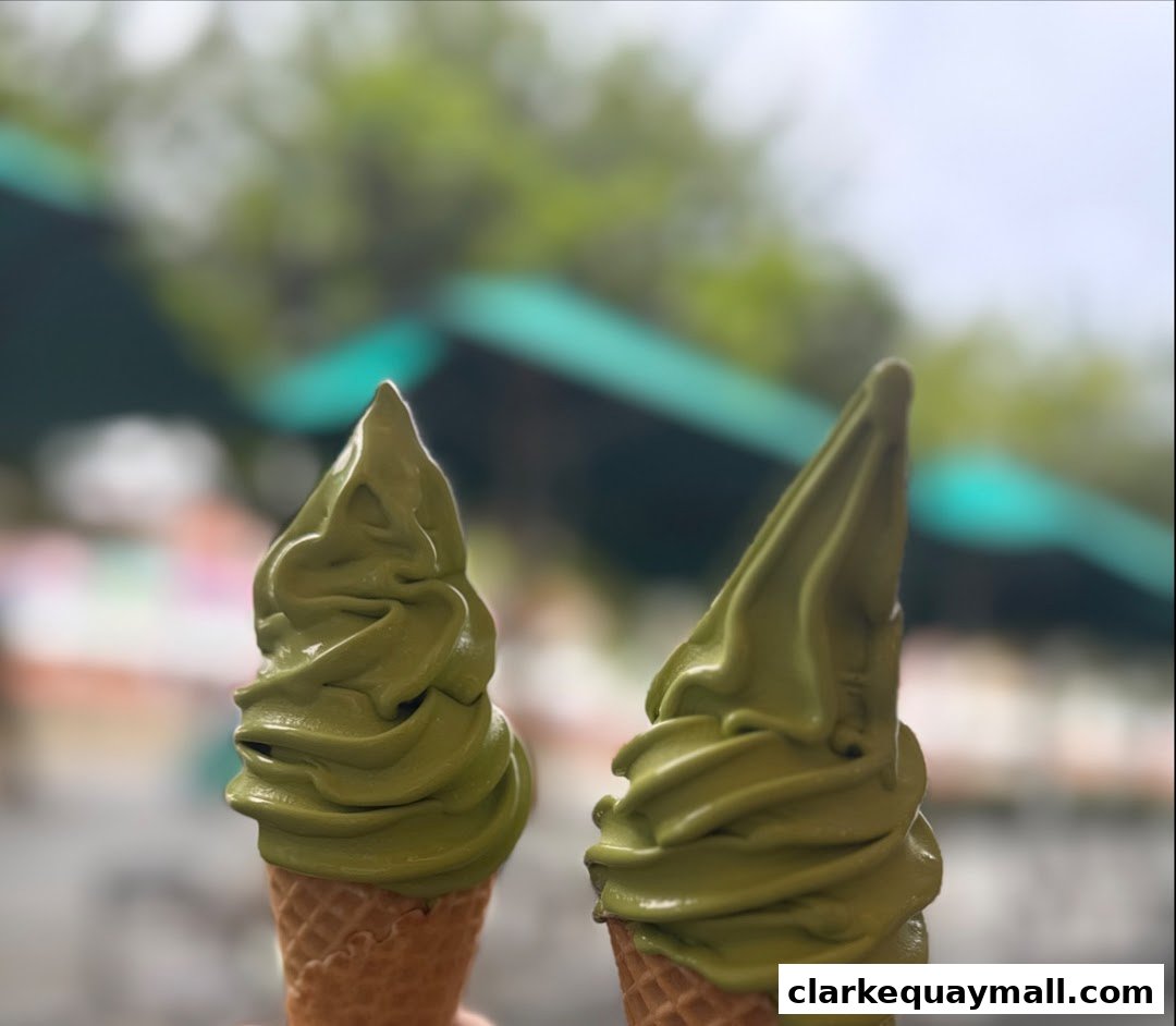Two green soft-serve ice cream cones with waffle cones.