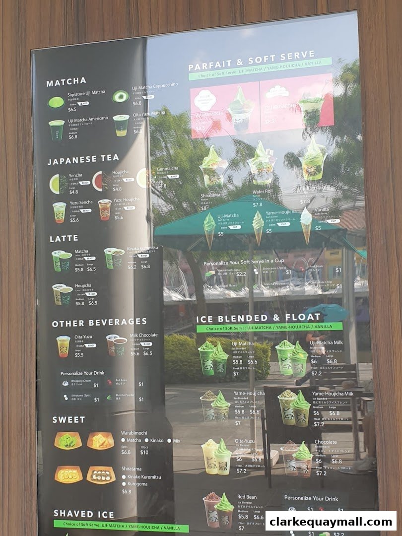 A menu board displaying various matcha, Japanese tea, latte, and dessert items with prices.